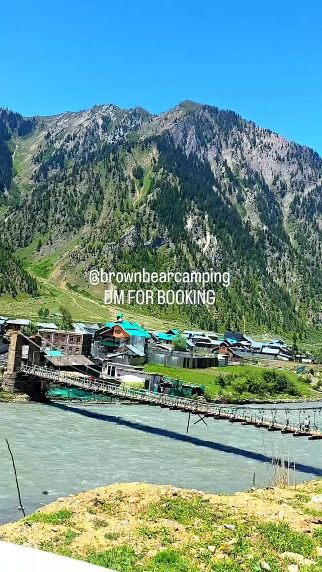 Suspension bridge over the river with mountains behind